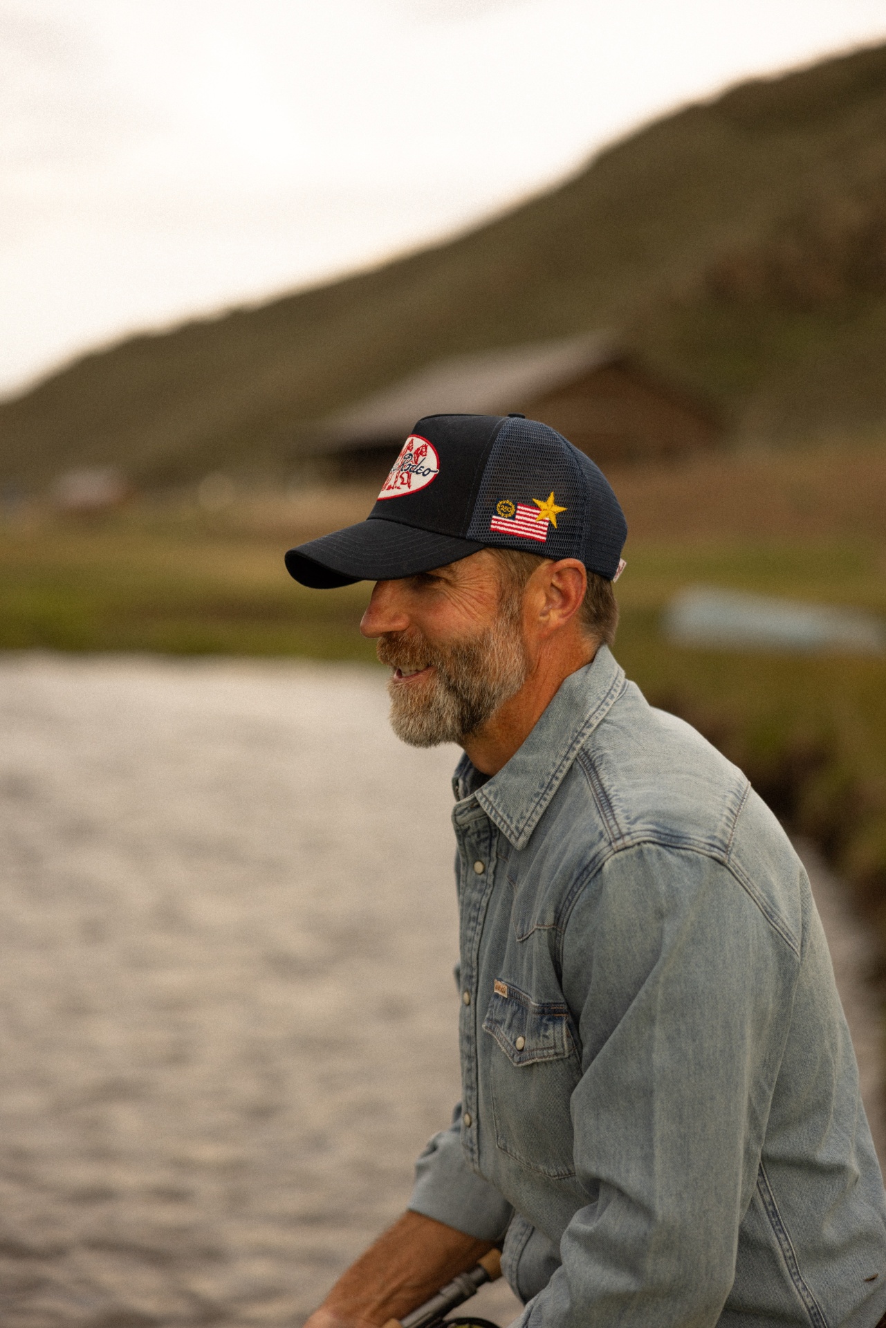 Cowboy in denim shirt wearing custom rodeo trucker hat